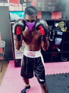 Coach Krishna in his boxing gloves after a sparring session.