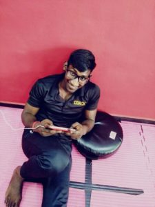 Coach Krishna enjoying a game of Mobile Legends on the floor