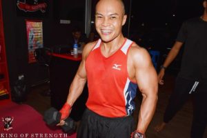 Happily Smiling Boxer Lifting Dumbbells