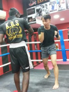Coach Krishna demonstrating dodging techniques to a student during training