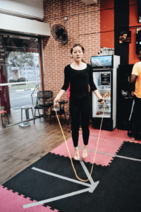 Gym member skipping rope with skill 