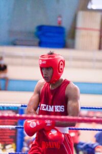 Coach Ravi, a proud representative of KOS, in the midst of an intense boxing match.